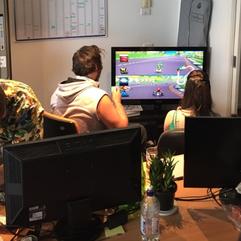 Employees playing Mario Kart in GTG Network's Melbourne Office